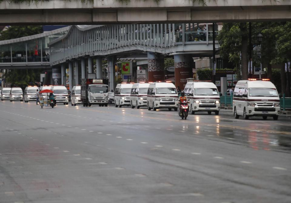 Vehicles carry police taking position in a business district where anti-government protesters sayid they will meet in Bangkok, Thailand, Friday, Oct. 16, 2020. Police announced Friday they would block roads leading to Bangkok’s Rajprasong intersection, where Thursday's rally was held, after protesters called on supporters to mass again. (AP Photo/Sakchai Lalit)