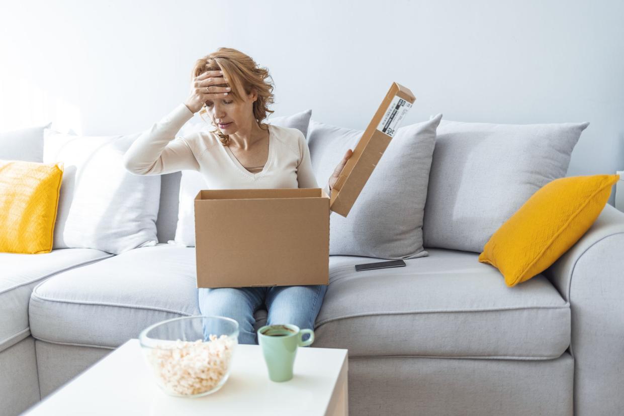 Angry confused woman unpacking parcel, wrong or broken order