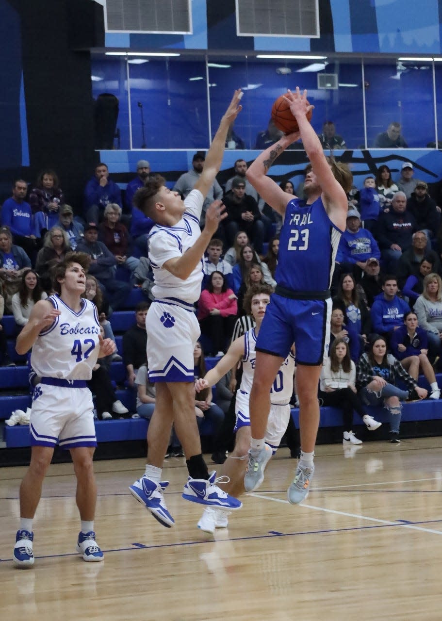 Buckeye Trail's Garrett Burga gets off a shot over Cambridge's Davion Bahr during a regular season contest. Burga and Bahr made the District 12 First Team in their respective divisions, Bahr (II) and Burga (III).