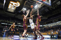 Pittsburgh's Femi Odukale, center, shoots between Minnesota's Jamison Battle, center left, and Charlie Daniels (15) during the first half of an NCAA college basketball game Tuesday, Nov. 30, 2021, in Pittsburgh. (AP Photo/Keith Srakocic)