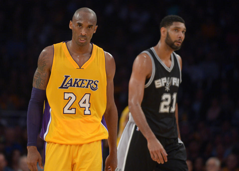 Nov 14, 2014; Los Angeles, CA, USA; Los Angeles Lakers guard Kobe Bryant (24) and San Antonio Spurs forward Tim Duncan (21) react at Staples Center. The Spurs defeated the Lakers 93-80. Mandatory Credit: Kirby Lee-USA TODAY Sports  