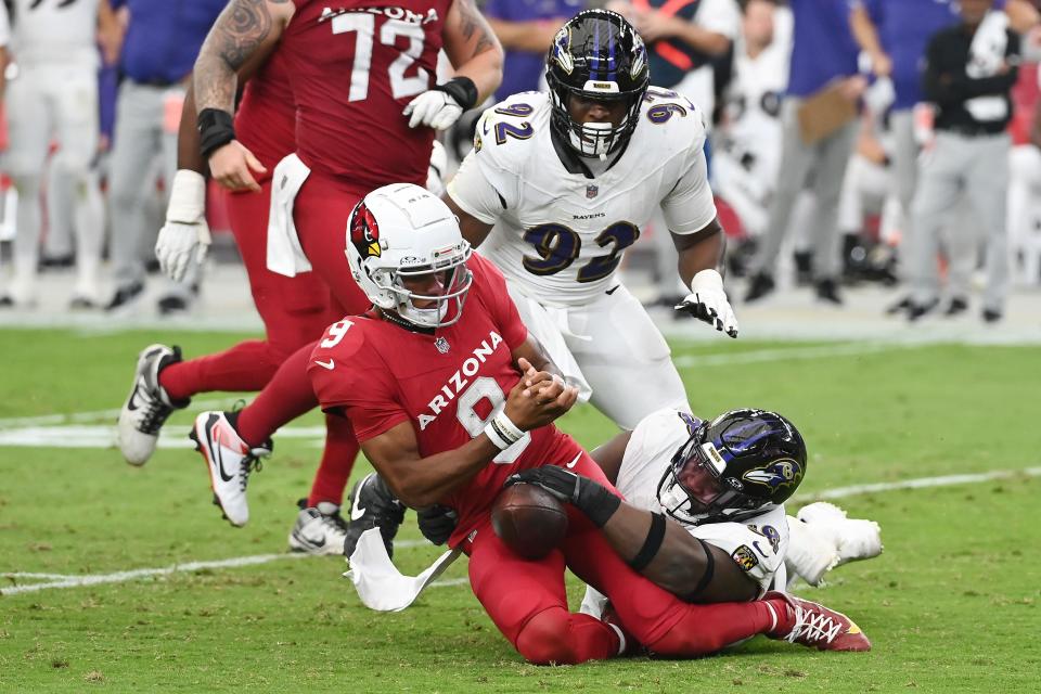 GLENDALE, ARIZONA - OCTOBER 29: Michael Pierce #58 of the Baltimore Ravens forces a fumble by Joshua Dobbs #9 of the Arizona Cardinals during the third quarter at State Farm Stadium on October 29, 2023 in Glendale, Arizona. (Photo by Norm Hall/Getty Images)