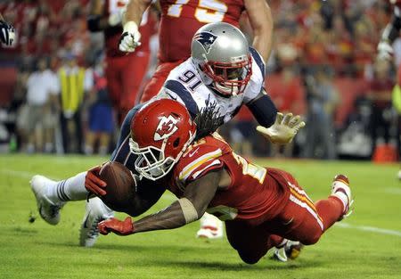 Sep 29, 2014; Kansas City, MO, USA; Kansas City Chiefs running back Jamaal Charles (25) fumbles the ball into the end zone while being tackled by New England Patriots outside linebacker Jamie Collins (91) in the second half at Arrowhead Stadium. John Rieger-USA TODAY Sports