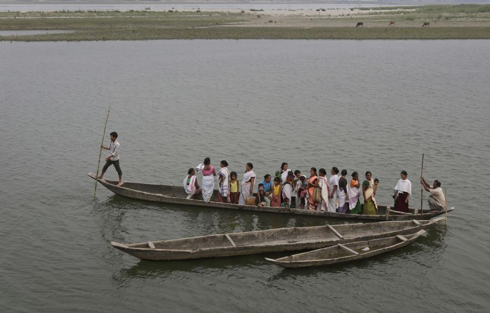 Mishing tribal women on a country boat head towards a polling station to cast their votes during the first phase of elections at Misamora Sapori, an island in the River Brahmaputra in the northeastern Assam state, India, Monday, April 7, 2014. (AP Photo/Anupam Nath)