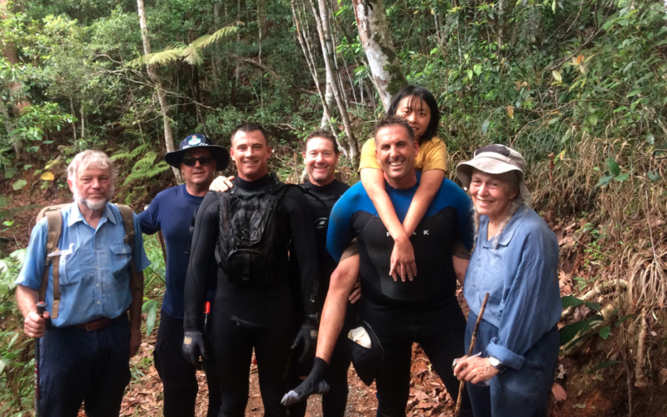 Yang Chen with rescuers after she was miraculously found alive. Source: Queensland Police