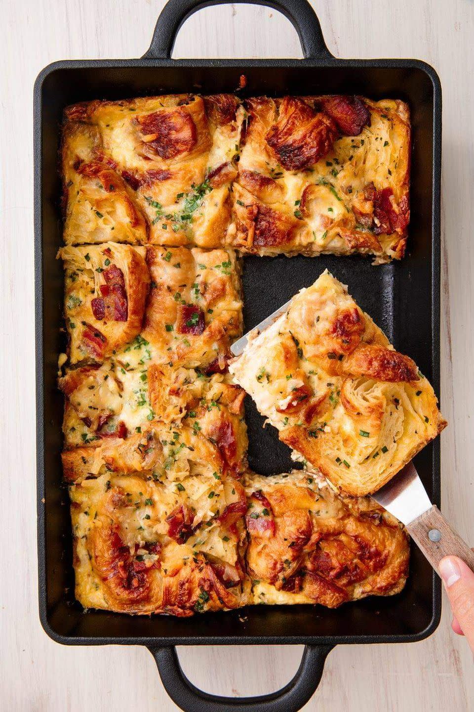 <p>Meet one of our favorite holiday-worthy <a href="https://www.delish.com/cooking/g2669/breakfast-casserole-recipes/" rel="nofollow noopener" target="_blank" data-ylk="slk:breakfast bakes;elm:context_link;itc:0;sec:content-canvas" class="link ">breakfast bakes</a>. The contrast between the crispy, flaky edges of the croissant and the soft, cheesy middle is very special. If you're able to, assemble everything the night before and bake it the next morning.<br><br>Get the <strong><a href="https://www.delish.com/cooking/recipe-ideas/a19448795/cheesy-croissant-casserole-recipe/" rel="nofollow noopener" target="_blank" data-ylk="slk:Cheesy Croissant Casserole recipe;elm:context_link;itc:0;sec:content-canvas" class="link ">Cheesy Croissant Casserole recipe</a></strong>. </p>