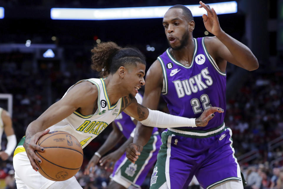 Houston Rockets guard Jalen Green, left, drives around Milwaukee Bucks forward Khris Middleton (22) during the first half of an NBA basketball game Sunday, Dec. 11, 2022, in Houston. (AP Photo/Michael Wyke)