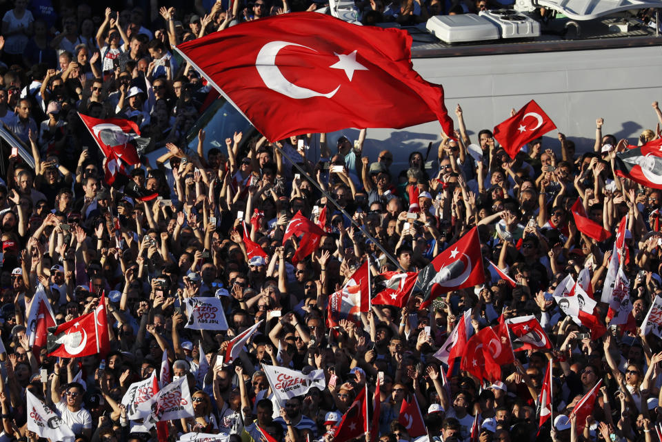 Thousands of supporters surround a bus from where Ekrem Imamoglu, the new Mayor of Istanbul from Turkey's main opposition opposition Republican People's Party (CHP) makes a speech after he took over office, in Istanbul, Thursday, June 27, 2019. Imamoglu is formally taking office as mayor of Istanbul four days after he won a repeat election in Turkey's largest city and commercial hub. (AP Photo/Lefteris Pitarakis)