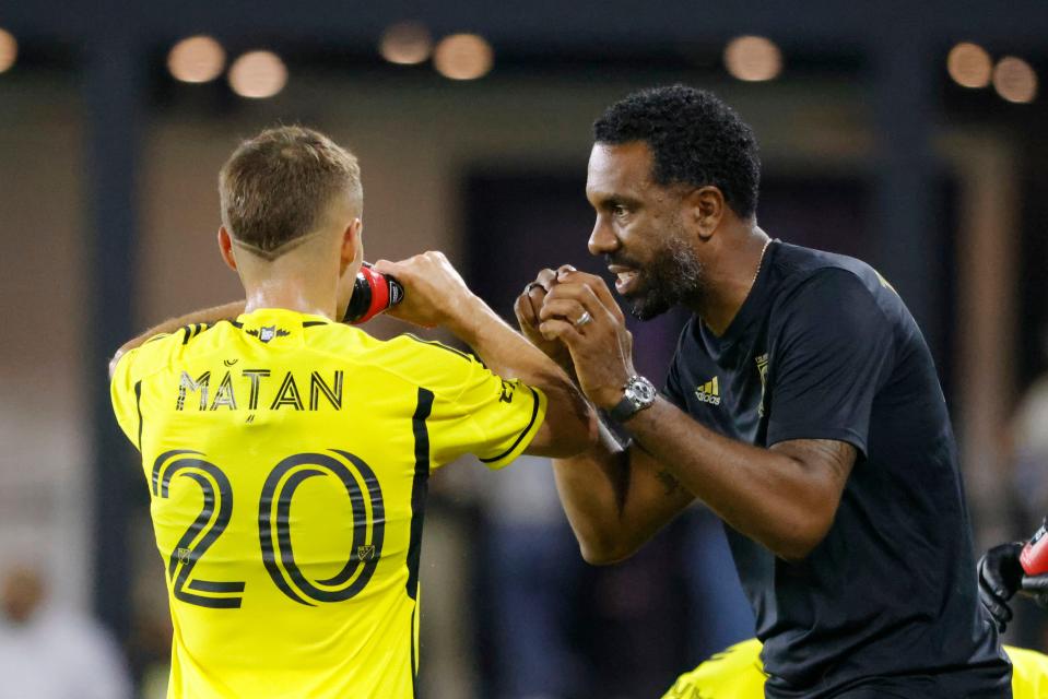 Sep 28, 2024; Washington, District of Columbia, USA; Columbus Crew head coach Wilfried Nancy talks to Columbus Crew midfielder Alexandru Matan (20) on the sidelines during the second half against the D.C. United at Audi Field. Mandatory Credit: Amber Searls-Imagn Images