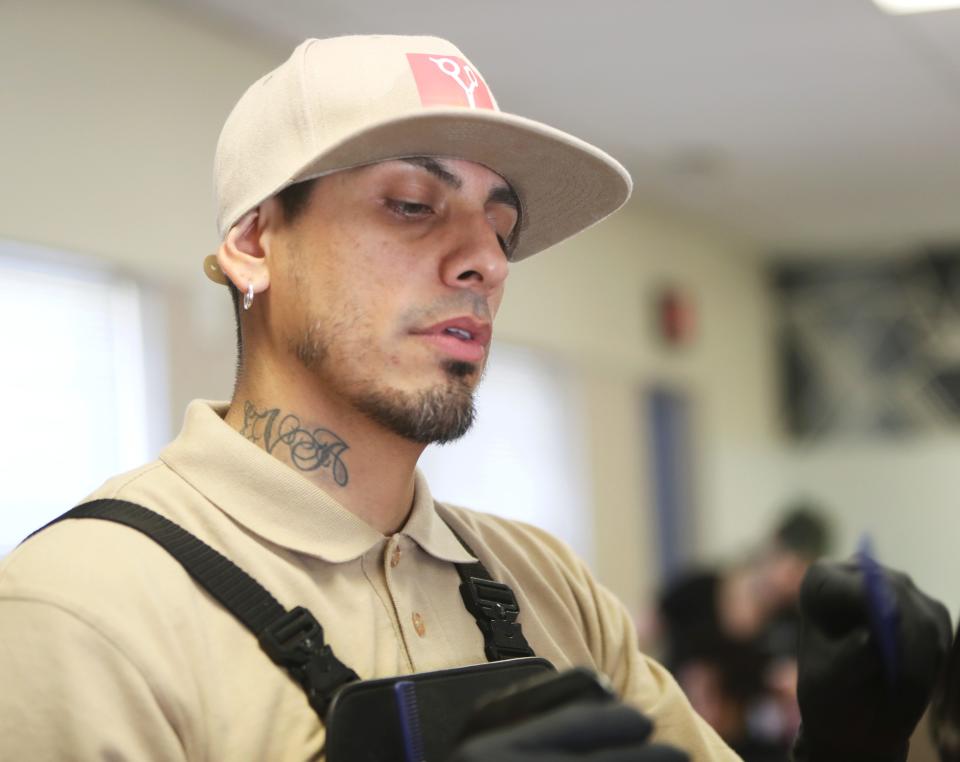 David Rodriguez of ClipDart cuts hair in Glendale on Saturday, July 22, 2023.