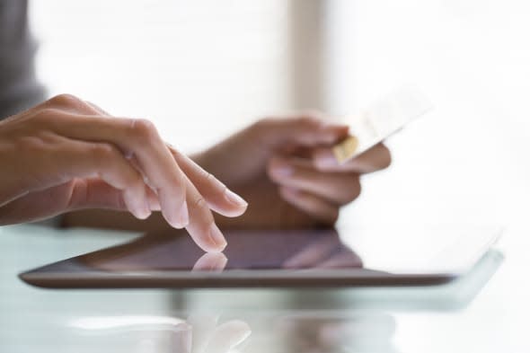 Woman shopping using tablet pc and credit card