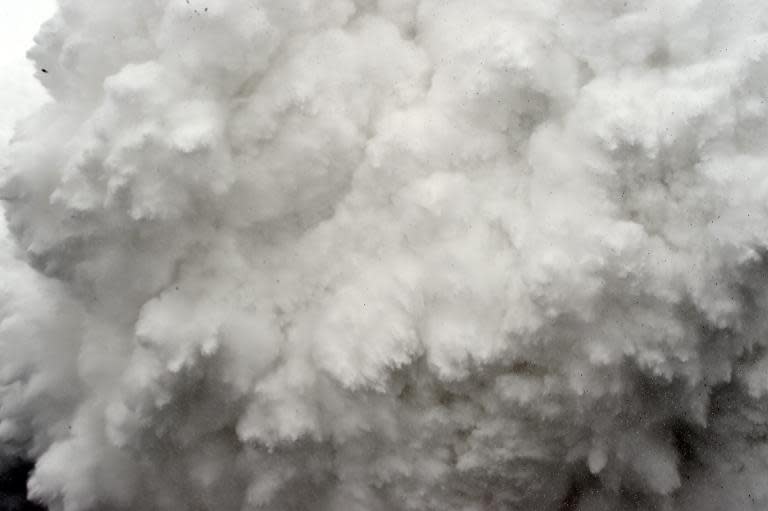 A cloud of snow and debris triggered by an earthquake roars towards Everest Base Camp, moments ahead of flattening part of the camp in the Himalayas, on April 25, 2015