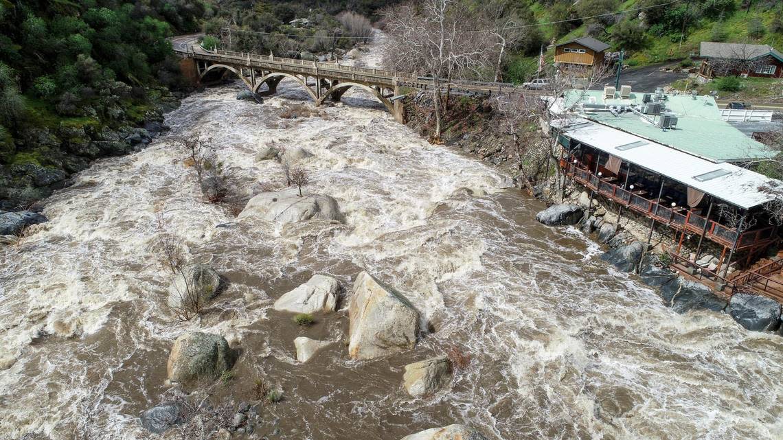 Heavy storm runoff fills the Kaweah River at the Pumpkin Hollow Bridge and the Gateway Restaurant and Lodge on Highway 198 in Three Rivers on Saturday, March 11, 2023.