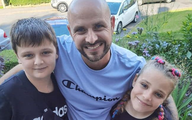 Jason Bennett with his son, John, and daughter, Lacey. The children were among four people found dead at a house in Killamarsh, Derbyshire, on Sunday