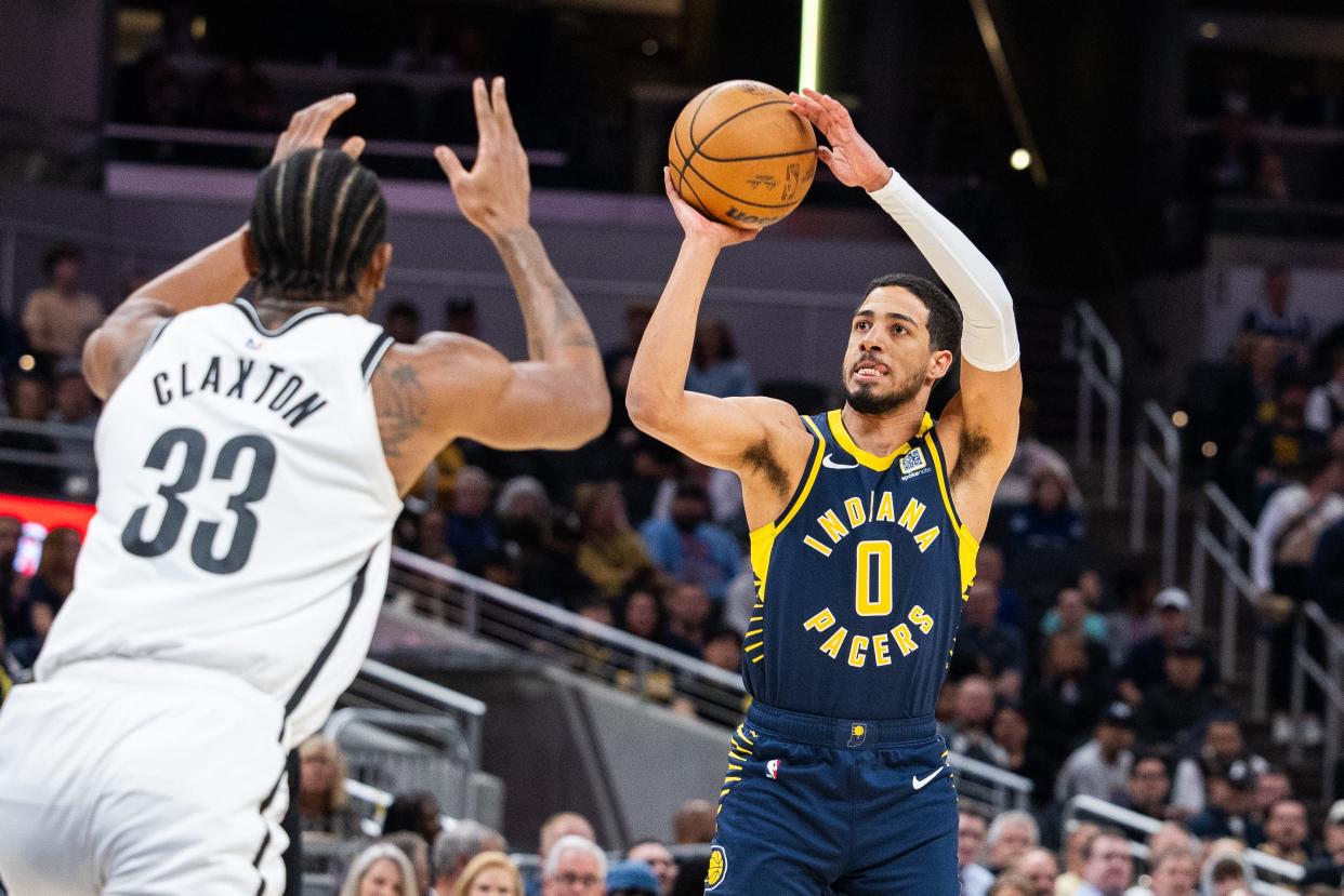 Apr 1, 2024; Indianapolis, Indiana, USA; Indiana Pacers guard Tyrese Haliburton (0) shoots the ball while Brooklyn Nets center Nic Claxton (33) defends in the first half at Gainbridge Fieldhouse. Mandatory Credit: Trevor Ruszkowski-USA TODAY Sports