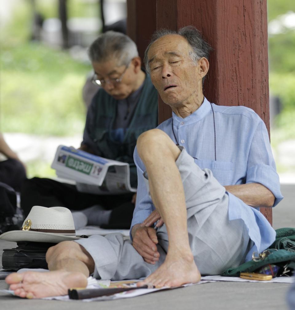 FILE - In this Monday, July 12, 2010 file picture an elderly South Korean man takes a nap while on a lunch beak in Seoul, South Korea. While most people born in rich countries will live longer by 2030 with women in South Korea estimated to reach at least 91 Americans will have among the lowest life expectancy of any developed country, a new study predicts. (AP Photo/ Lee Jin-man, FILE)