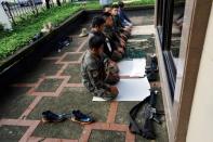 Philippines police officers perform Eid al-Fitr prayers outside a mosque inside city hall compound as government forces continue their assault against insurgents from the Maute group, who have taken over large parts of Marawi City , Philippines June 25, 2017. REUTERS/Jorge Silva