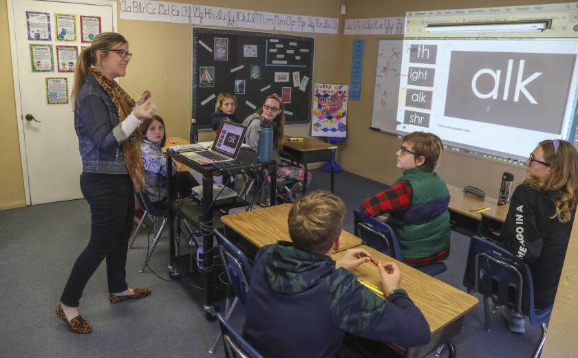 Teacher Kerry Donoghue works with 6th and 7th grade students on a phonics lesson at the New Bridge School on January 30, 2020 in Poway, California. New Bridge caters to students with dyslexia.