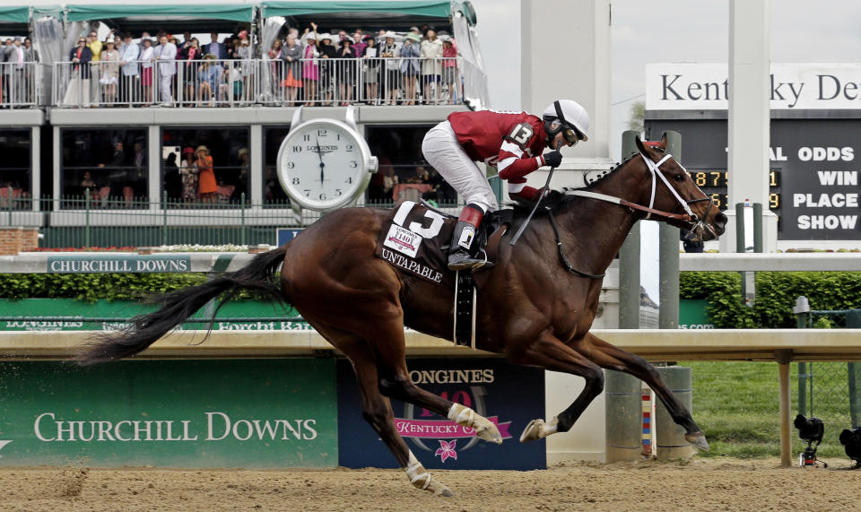 Rosie Napravnik rides Untapable to victory during the 140th running of the Kentucky Oaks horse race at Churchill Downs Friday, May 2, 2014, in Louisville, Ky. (AP Photo/Morry Gash)