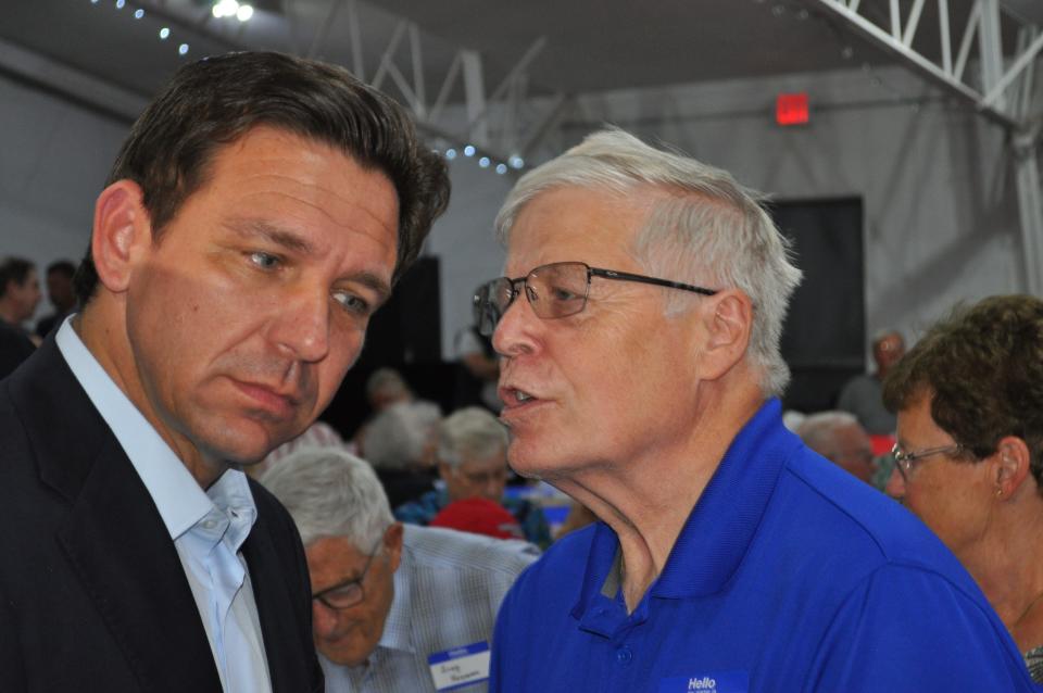 Presidential candidate and Florida Gov. Ron DeSantis gets an earful from an Iowa voter while campaigning in Adel, Iowa.
