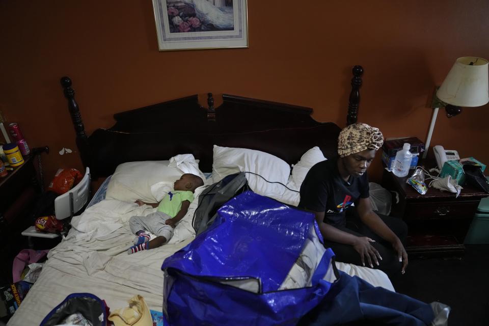 Ida Cartlidge, who lived in a mobile home park that was destroyed by a deadly tornado, sits on a bed with her son Nolan, 1, as she talks about her experience in their room in the Rolling Fork Motel, where they are now living, in Rolling Fork, Miss., Tuesday, May 9, 2023. “It picked up the home one time, set it down. It picked it up again, set it down. It picked it up a third time, and we were in the air,” she said. (AP Photo/Gerald Herbert)