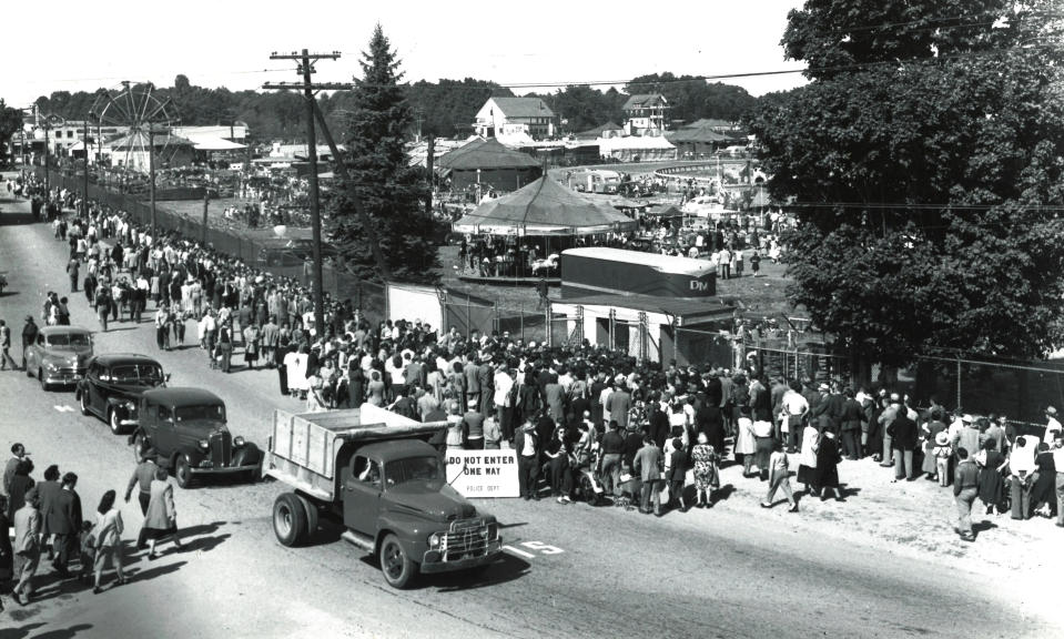 In this undated photo, great crowds lined West Street to enter the Forest Avenue gate of the Brockton Fair when the ferris wheel and the merry-go-round were among the few rides offered to patrons. (Stanley A. Bauman/The Enterprise file photo)