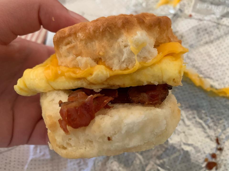 hand holding Chick-fil-a breakfast sandwich