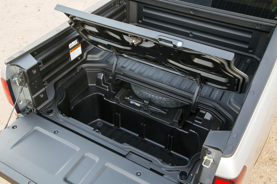 This undated photo provided by American Honda Motor Co. shows the 2020 Honda Ridgeline and its in-bed trunk. The Honda Ridgeline has been Edmunds’ top-rated midsize pickup truck since its debut four years ago. One of the main reasons is its sensible approach to common problems. (Courtesy of American Honda Motor Co. via AP)