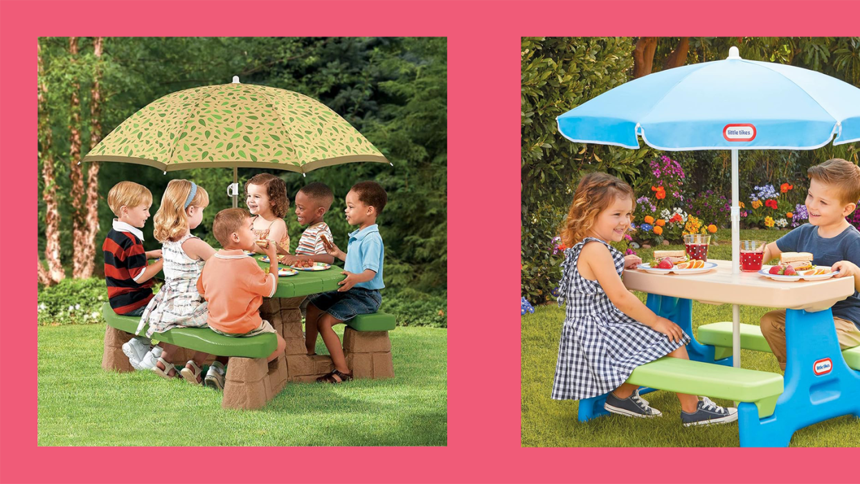 a group of kids sitting around a table with umbrellas