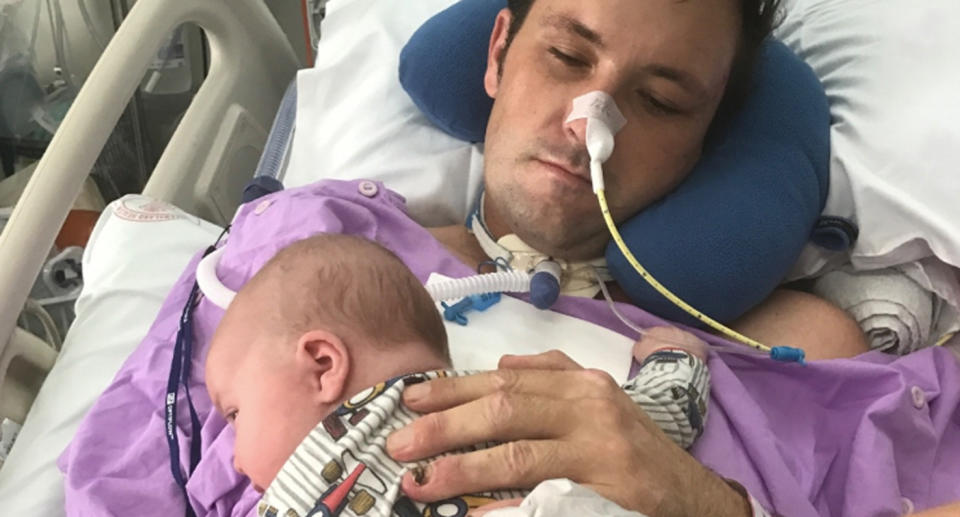 Kenneth Allan has held his young son for the first time since he was placed in a coma after he was struck by a car outside his home. Source: GoFundMe