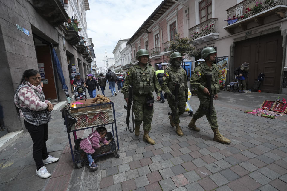 Soldiers patrol near the government palace during a state of emergency in Quito, Ecuador, Tuesday, Jan. 9, 2024. The country has seen a series of attacks after the government imposed a state of emergency in the wake of the apparent escape of a powerful gang leader from prison. (AP Photo/Dolores Ochoa)