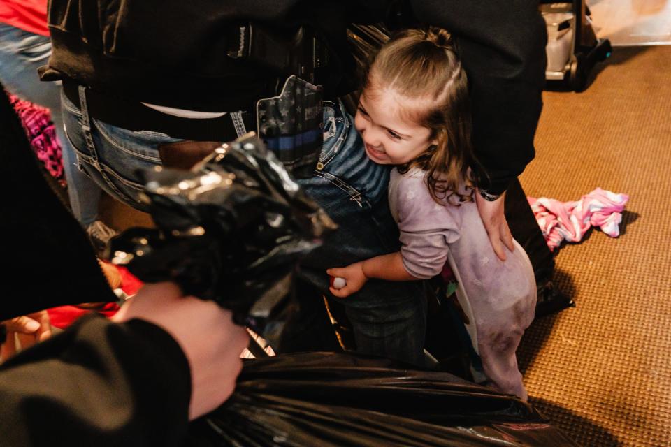 Raven Byers, 2, embraces New Philadelphia Police Department Detective Chad Dorsey, during the 14th annual Christmas with a Cop, Saturday, in Tuscarawas County. The event is sponsored and organized by the Fraternal Order of Police, Tuscora Lodge 4.