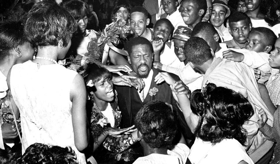 BOSTON, MA - MAY 18: Students swarm Bill Russell after he gave a speech at the Patrick T. Campbell Junior High School 