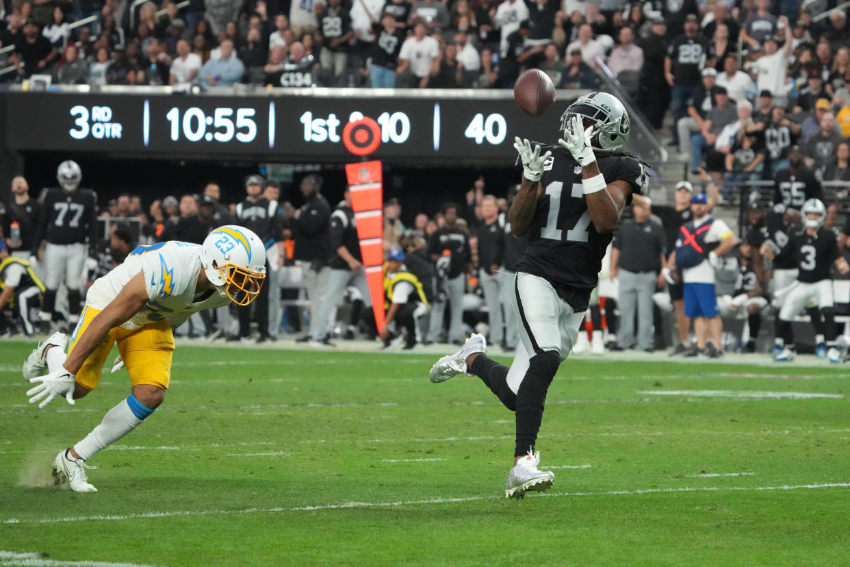 Dec 4, 2022; Paradise, Nevada, USA; Las Vegas Raiders wide receiver Davante Adams (17) scores on a 45-yard touchdown reception against Los Angeles Chargers cornerback Bryce Callahan (23) n the second half at Allegiant Stadium. The Raiders defeated the Chargers 27-20. Mandatory Credit: Kirby Lee-USA TODAY Sports
