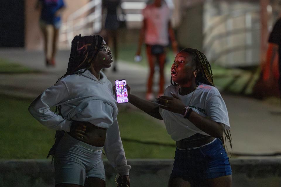 People are in shock after hearing multiple gun shots during a high school football game between Del City and Choctaw in Choctaw, Okla. on Friday, Aug. 25, 2023.