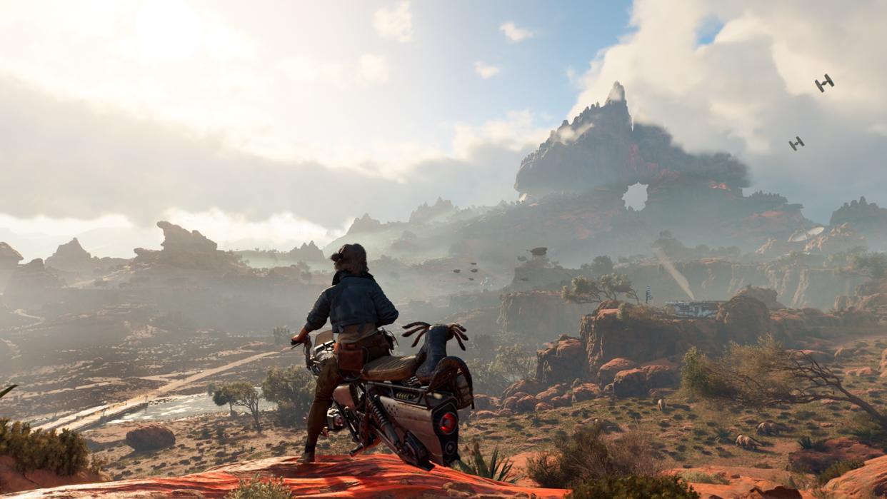  A woman on a speeder looks out over a savannah. 