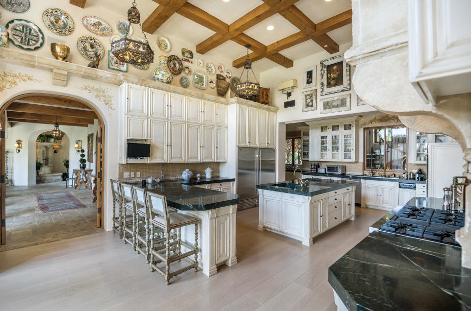 The chef's kitchen features professional appliances, a central island, and easy access to the family room. (Coldwell Banker)