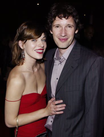 <p>Dave Hogan/Getty</p> Milla Jovovich and Paul W.S. Anderson arrive at the "Resident Evil" film premiere party on July 8, 2002 in London.