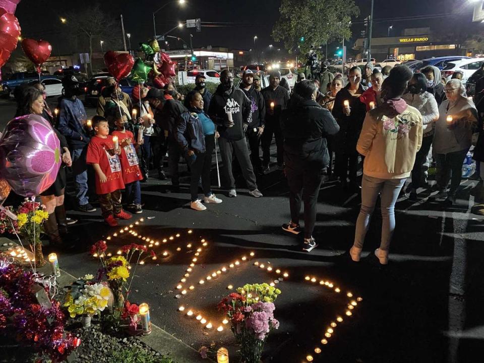 Family and friends gathered Thursday Jan. 20, 2022, at a candlelight vigil for Alynia Asiah Lawrence, who was killed in a shooting on Jan. 13, 2022, while sitting in a car in a parking lot on Stockton Boulevard in Sacramento, California.