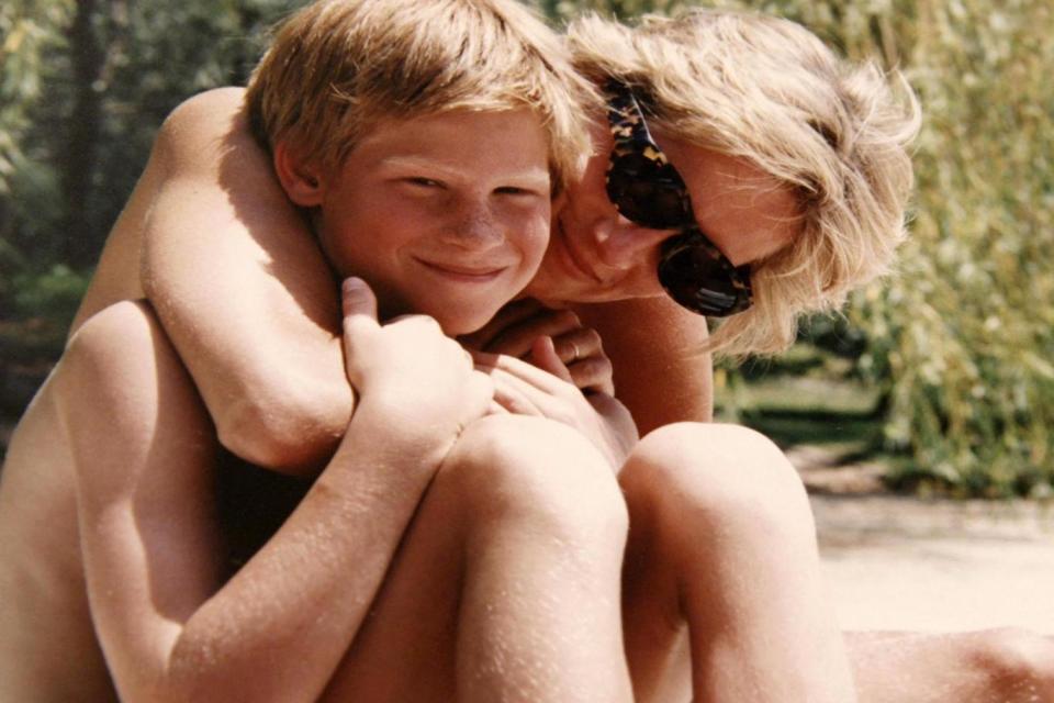 Diana, Princess of Wales embraces Prince Harry while on holiday (AFP/Getty Images)