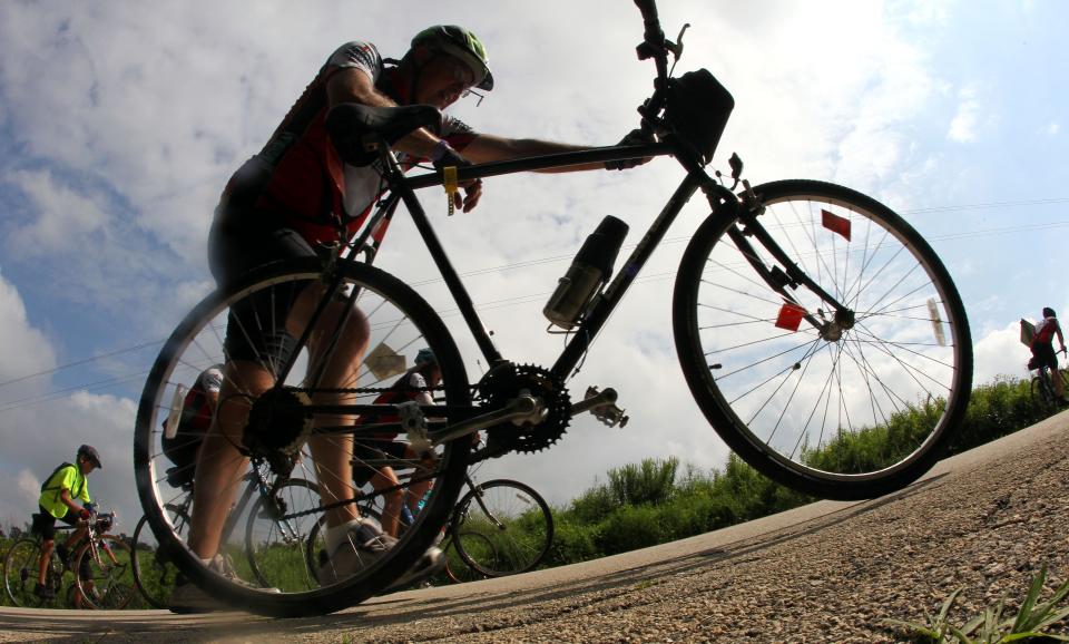 Many RAGBRAI riders became RAGBRAI walkers on their way up Potter Hill outside of Graf July 31, 2010. Many riders said the mile long, steep hill was the hardest hill they've ever had to climb.