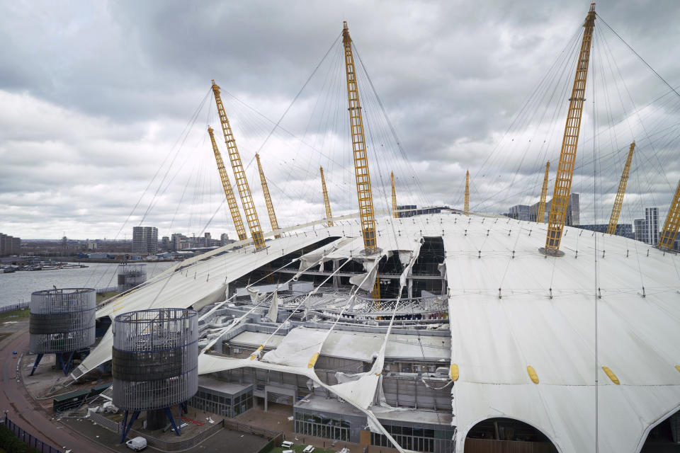 A view of damage to the roof of the O2 Arena, caused by Storm Eunice, in south east London, Friday, Feb. 18, 2022. London Fire Brigade said that there were no reports of any injuries as around 1,000 people were evacuated from the building, formerly known as the Millennium Dome, which hosts major events including concerts and features restaurants, bars, shops and a cinema. Millions of Britons were urged to cancel travel plans and stay indoors Friday amid fears of high winds and flying debris as the second major storm in the week prompted a rare "red" weather warning across southern England. (Stefan Rousseau/PA via AP)