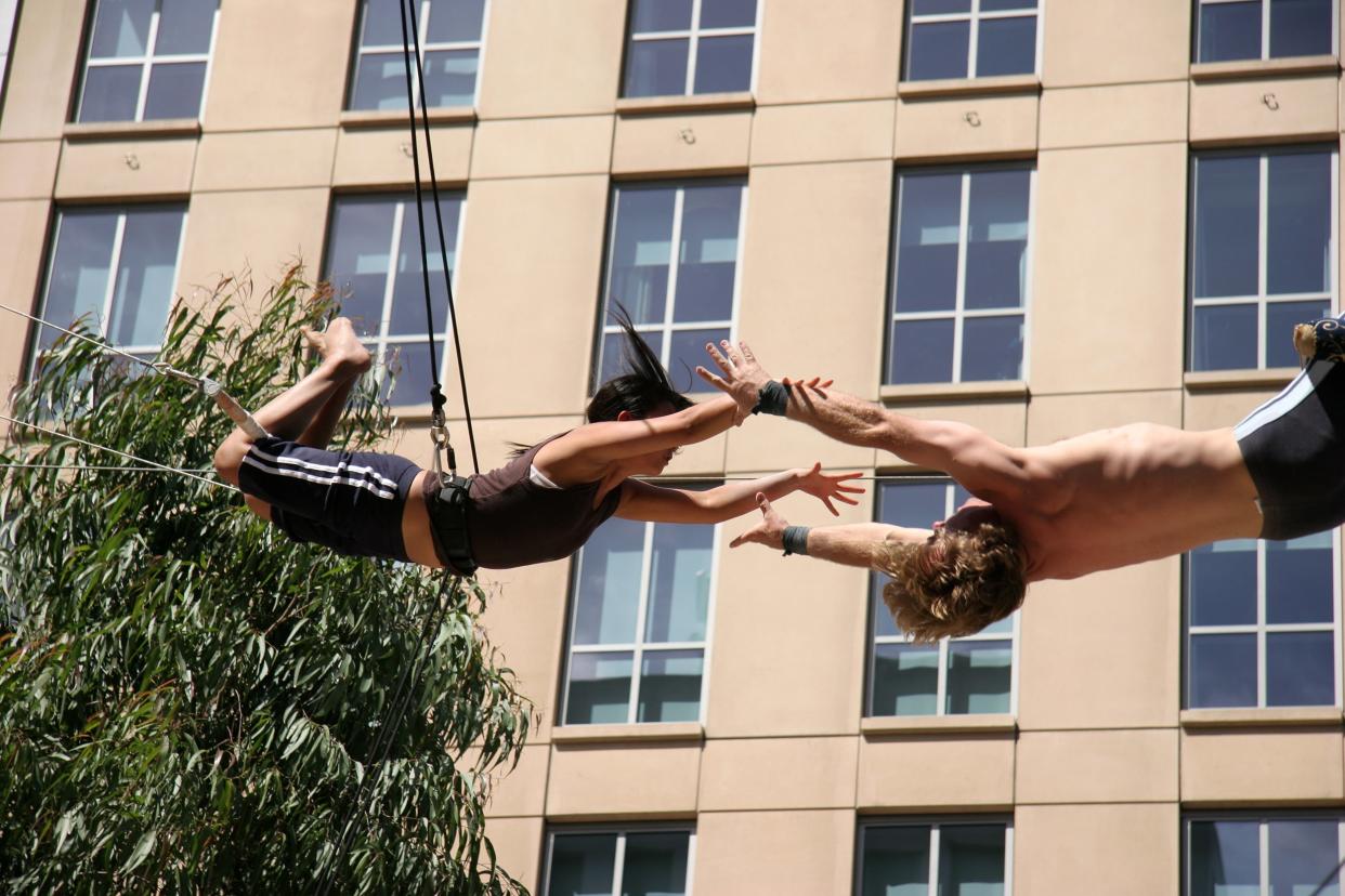 Two people on a trapeze