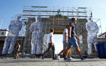 <p>A steel scaffolding is erected with giant figures displaying former East German border soldiers in front of the Brandenburg Gate for the upcoming celebrations to mark the anniversary of Germany’s unification in Berlin, Germany, September 21, 2018. REUTERS/Fabrizio Bensch </p>