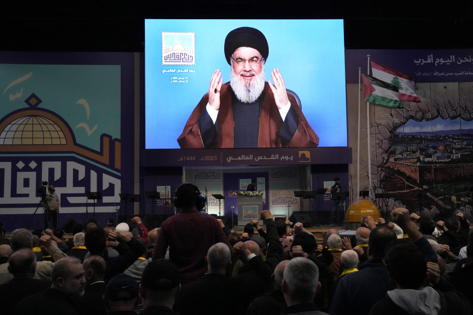 Hezbollah leader Sayyed Hassan Nasrallah greets his supporters through a screen via a video link from a secret place, during a rally to mark Jerusalem day, in a southern suburb of Beirut, Lebanon, Friday, April 14, 2023. Since Iran's Islamic Revolution in 1979, the rallies marking what is also known as al-Quds Day have typically been held on the last Friday of the Muslim holy month of Ramadan. (AP Photo/Hussein Malla)