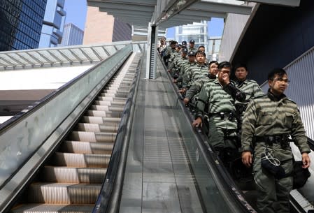 Police officers stand guard on an escalator ahead of Hong Kong Chief Executive Carrie Lam's annual policy address, after four months of anti-government protests, at the Legislative Council in Hong Kong