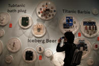 A visitor to SeaCity Museum looks at Titanic mechandise exhibited at the museum's Titanic exhibition on April 3, 2012 in Southampton, England. The new SeaCity Museum, which will open at 1.30pm on April 10, 100 years to the day since the Titanic set sail from the city. The museum, which cost 15 GBP million, promises to tell the largely untold story of Southampton's Titanic crew and the impact the tragedy had on the city, as well as featuring other aspects of the city's seafaring past. (Photo by Matt Cardy/Getty Images)