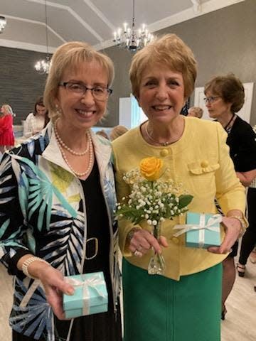 Chair of the Anniversary Committee Margie Peterson, left, led the recent Coterie meeting , and Marlene Admonius baked delicate cookies that were served up to those on hand in Tiffany blue boxes.