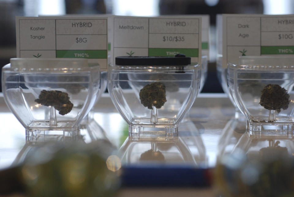 FILE - In this June 11, 2019 file photo Medical marijuana flowers await customers at the Minerva cannabis dispensary in Santa Fe, N.M. New Mexico would legalize recreational marijuana sales without exceptions for dissenting cities and counties under a rebooted proposal form legislators that emphasizes small business opportunities and ready access to pot for 80,000 current medical cannabis patients. Legalization for the first time enjoys the full throttled support of second-year Democratic Gov. Michelle Lujan Grisham, who set up a volunteer commission last year to vet health and public safety concerns about recreational cannabis and on Thursday, Jan. 16, 2020, pitched the benefits of the pot economy to a gathering business leaders. (AP Photo/Morgan Lee,File)