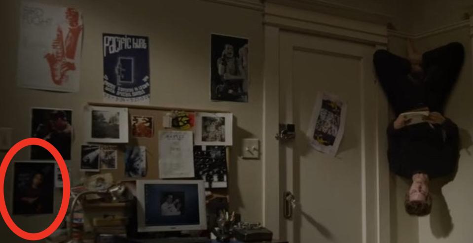 Peter hanging upside down from the wall in his room with a notebook in "The Amazing Spider-Man"